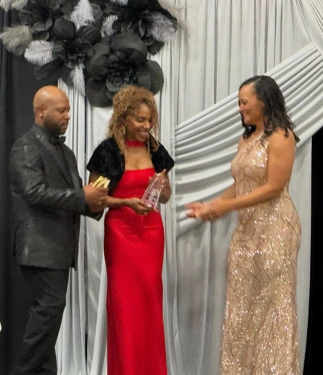 Carmen Best receiving an award on stage